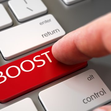  WinZip Registry Optimizer registry cleaner software features finger pressing on BOOST red key on white keyboard